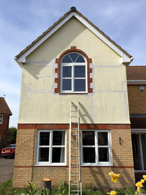 outside render repaired and painted